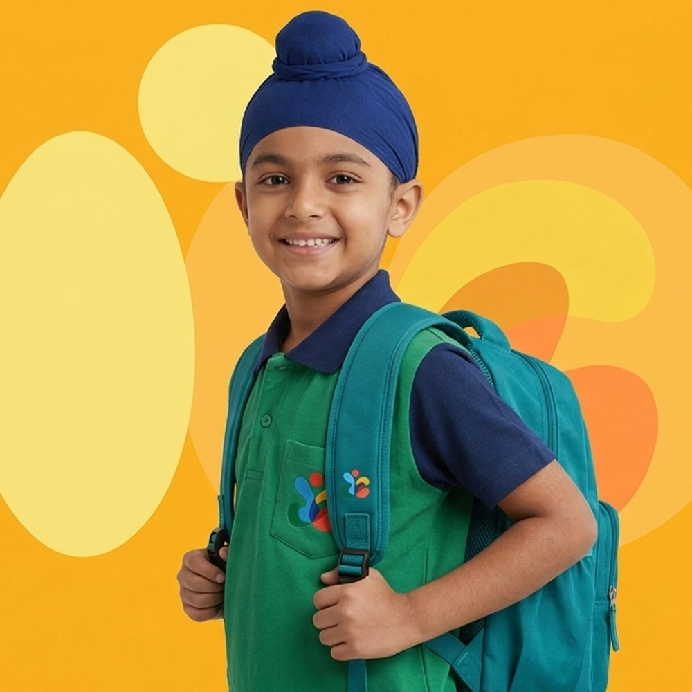 A young girl wearing glasses holding a tablet.